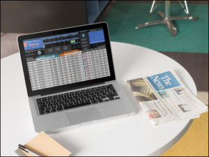 Image of the TJS Trading Log on a laptop with a tabletop setting